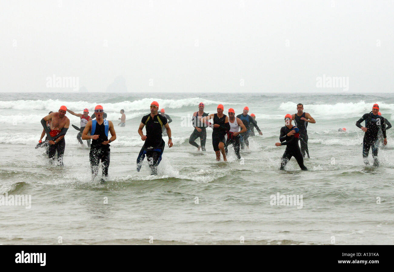 Competitors exiting the sea at the start of the Perranporth Triathlon Cornwall UK Stock Photo