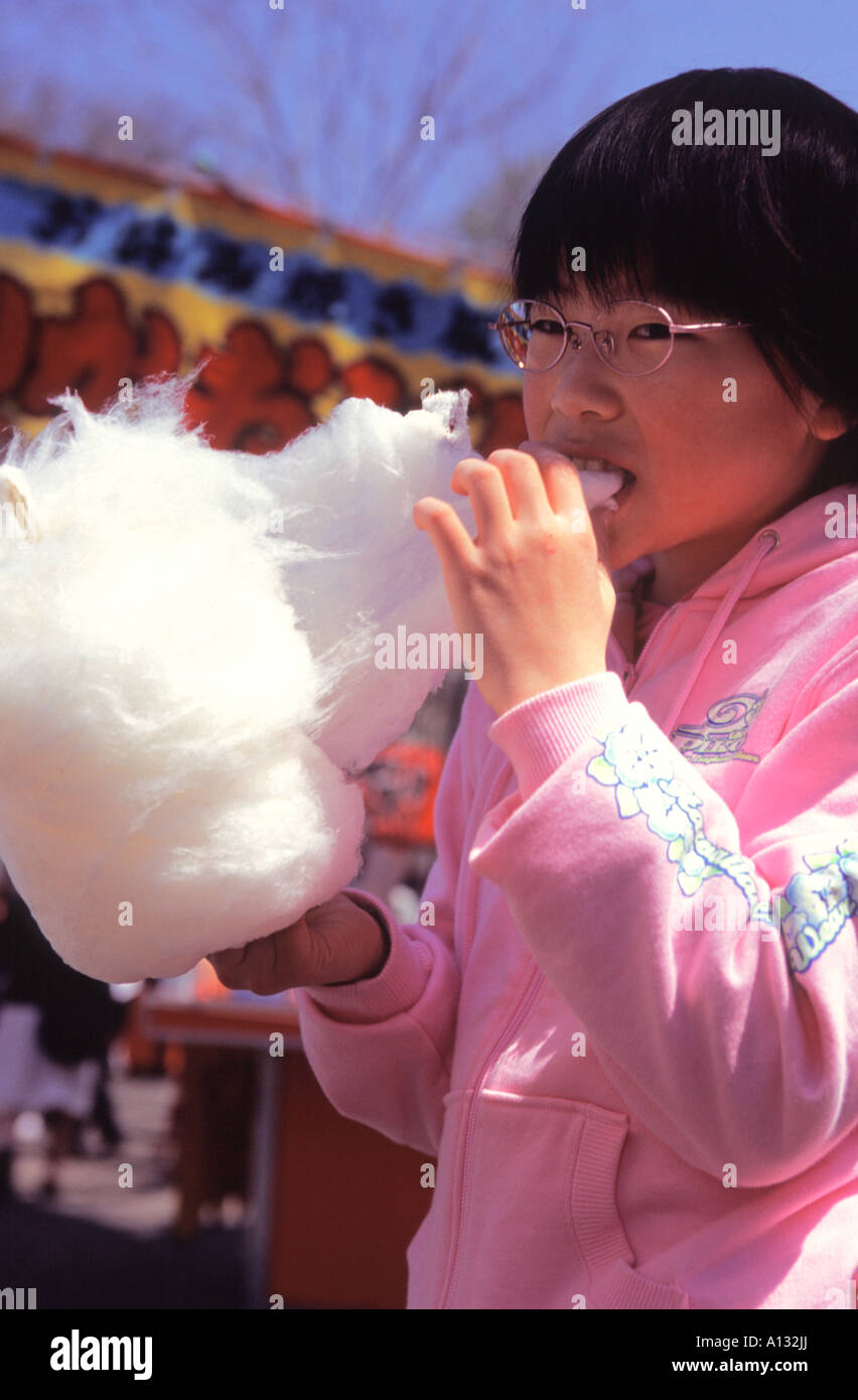A young Japanese girl eats fairy floss at a local festival in Maruyama