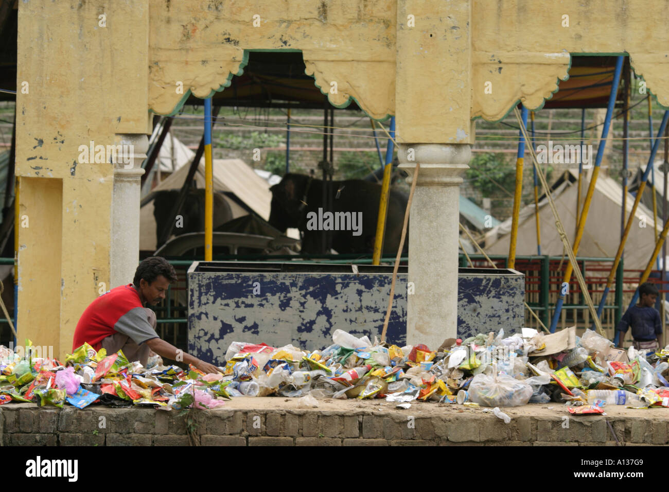 Man working among rubbish, India Stock Photo Alamy