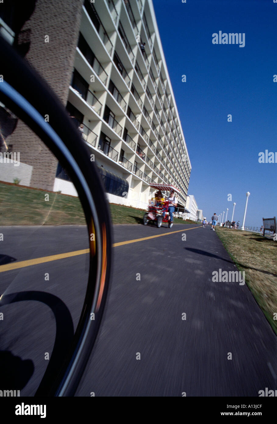 Bicycling on oceanfront resort area boardwalk Virginia Beach VA Stock