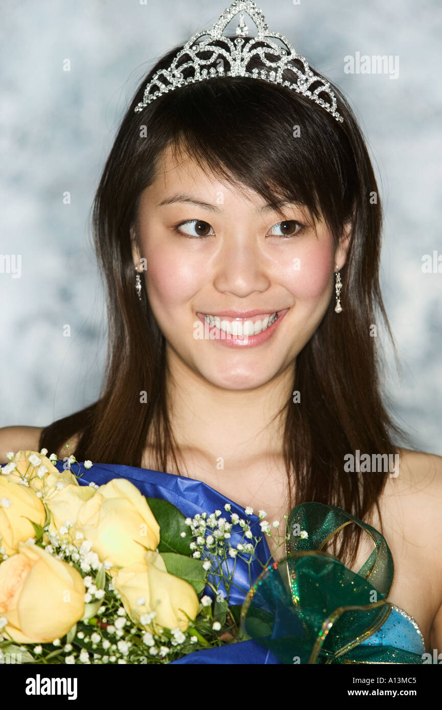 Young woman wearing tiara holding bouquet Stock Photo