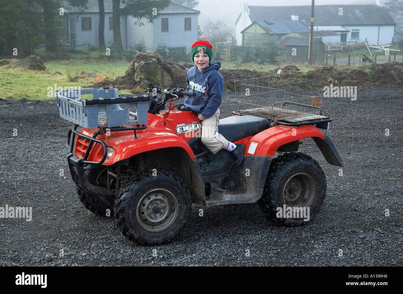 Young welsh farmers boy on quad bike, Snowdonia National Park, Gwyned, Wales, UK. Stock Photo