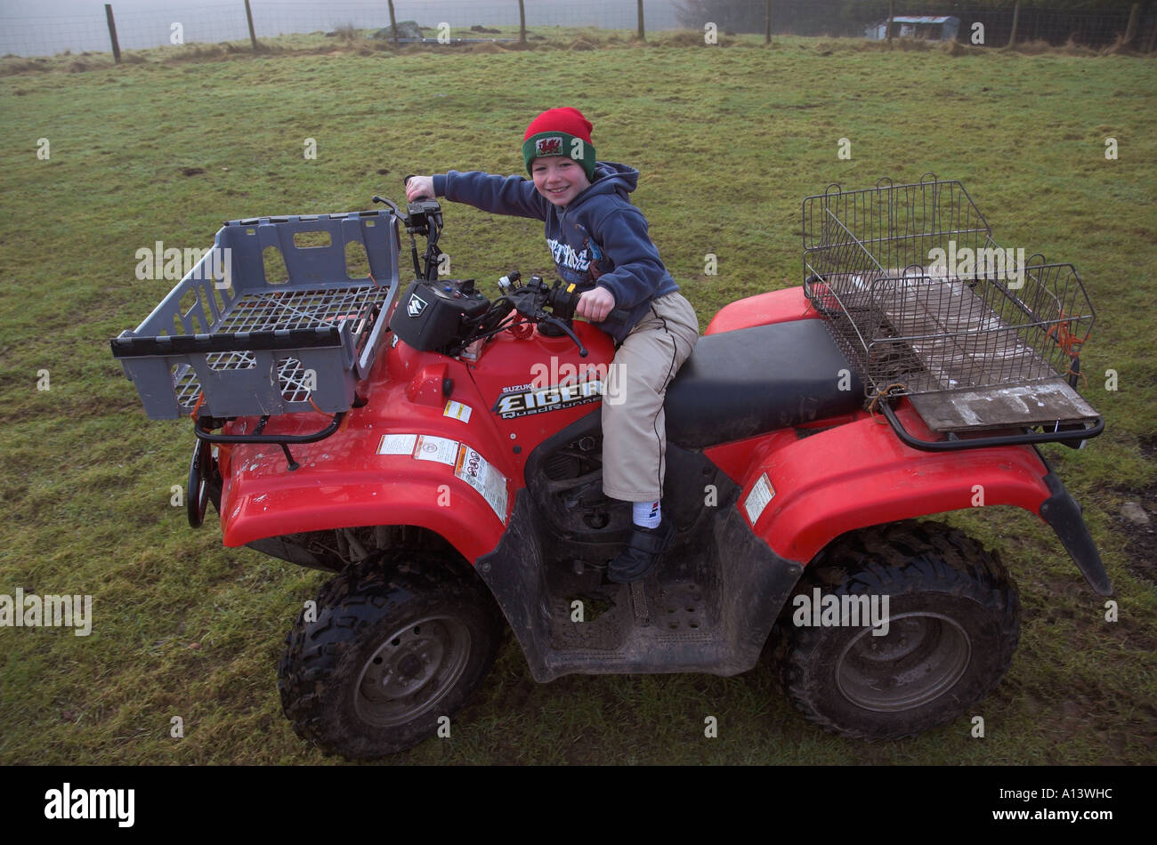 Young welsh farmers boy on quad bike, Snowdonia National Park, Gwyned, Wales, UK. Stock Photo