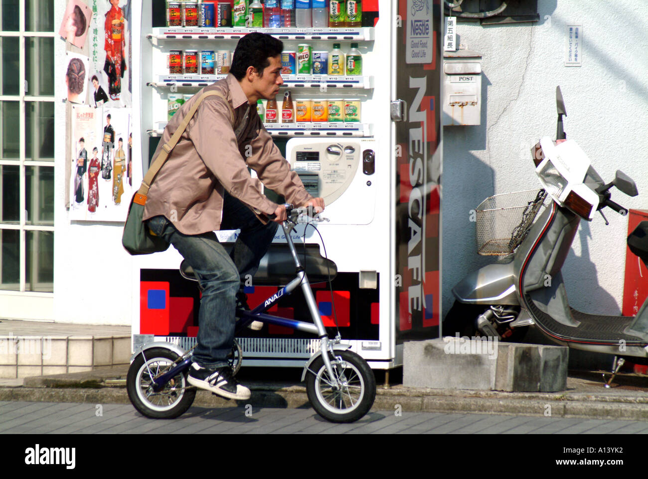 Man on a mini bike in Kyoto Japan Stock Photo Alamy