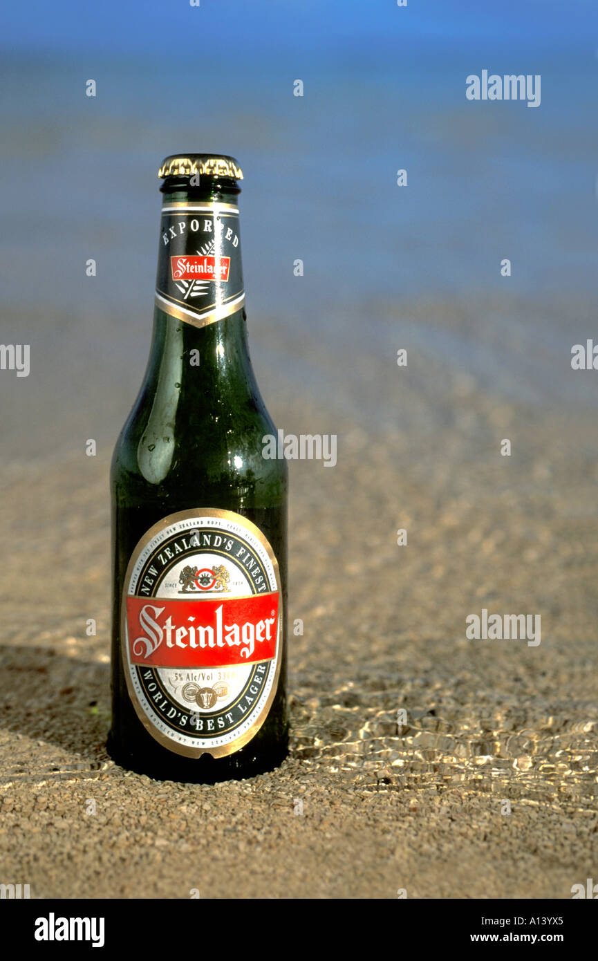 Bottle of New Zealand Steinlager beer on a Cook Islands beach Stock