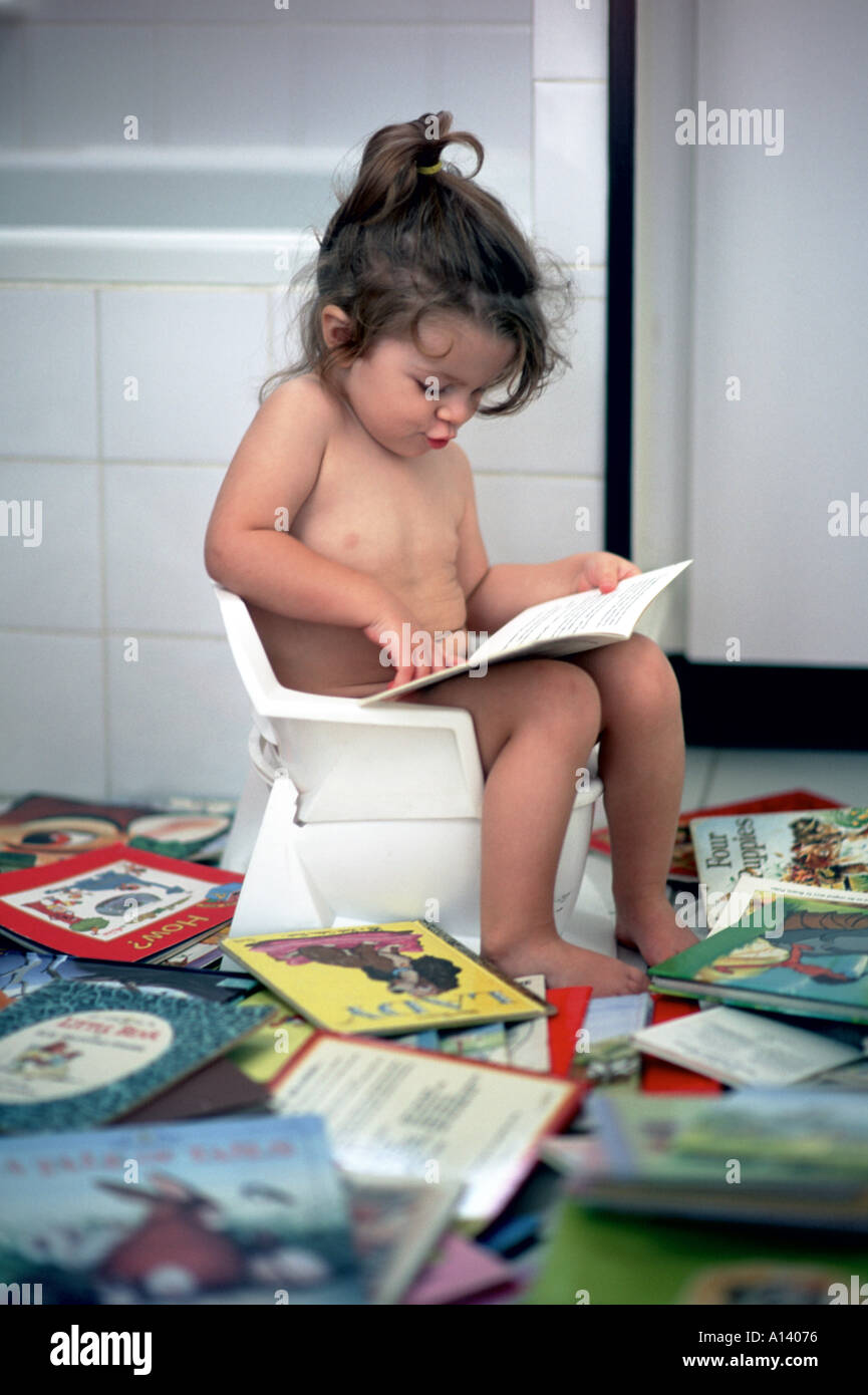pooping little girl  2 years old girl reading on the potty Stock Photo - Alamy