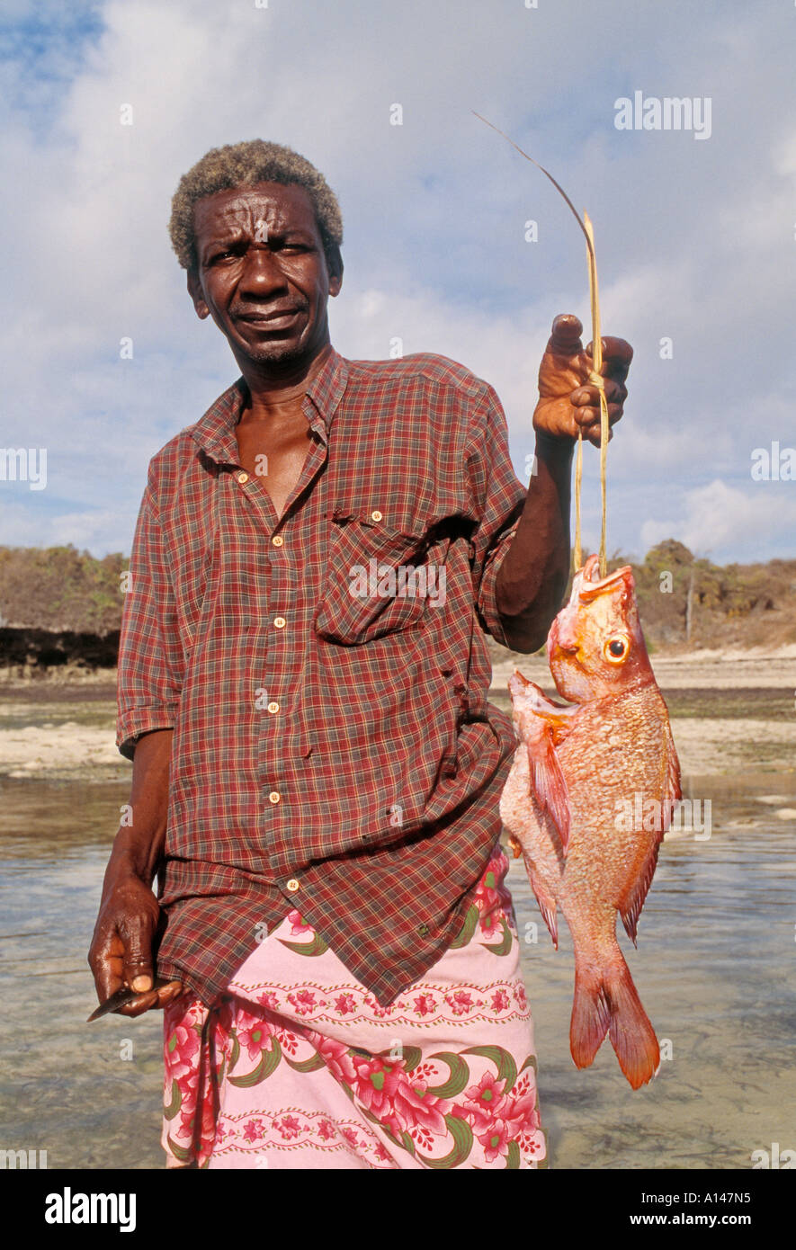 near Malindi Kenya Man showing fish he caught Stock Photo