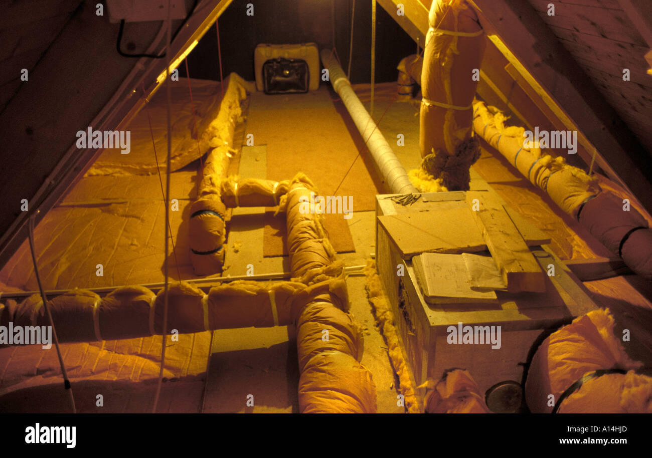 Heat exchanger pipes in loft of insulated house Stock Photo