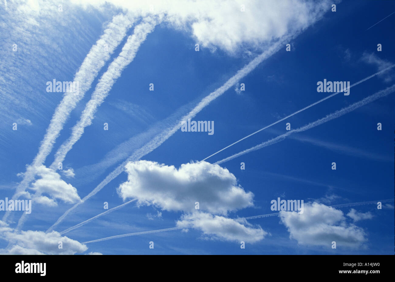 Jet streams fill the sky across East Devon in England Stock Photo