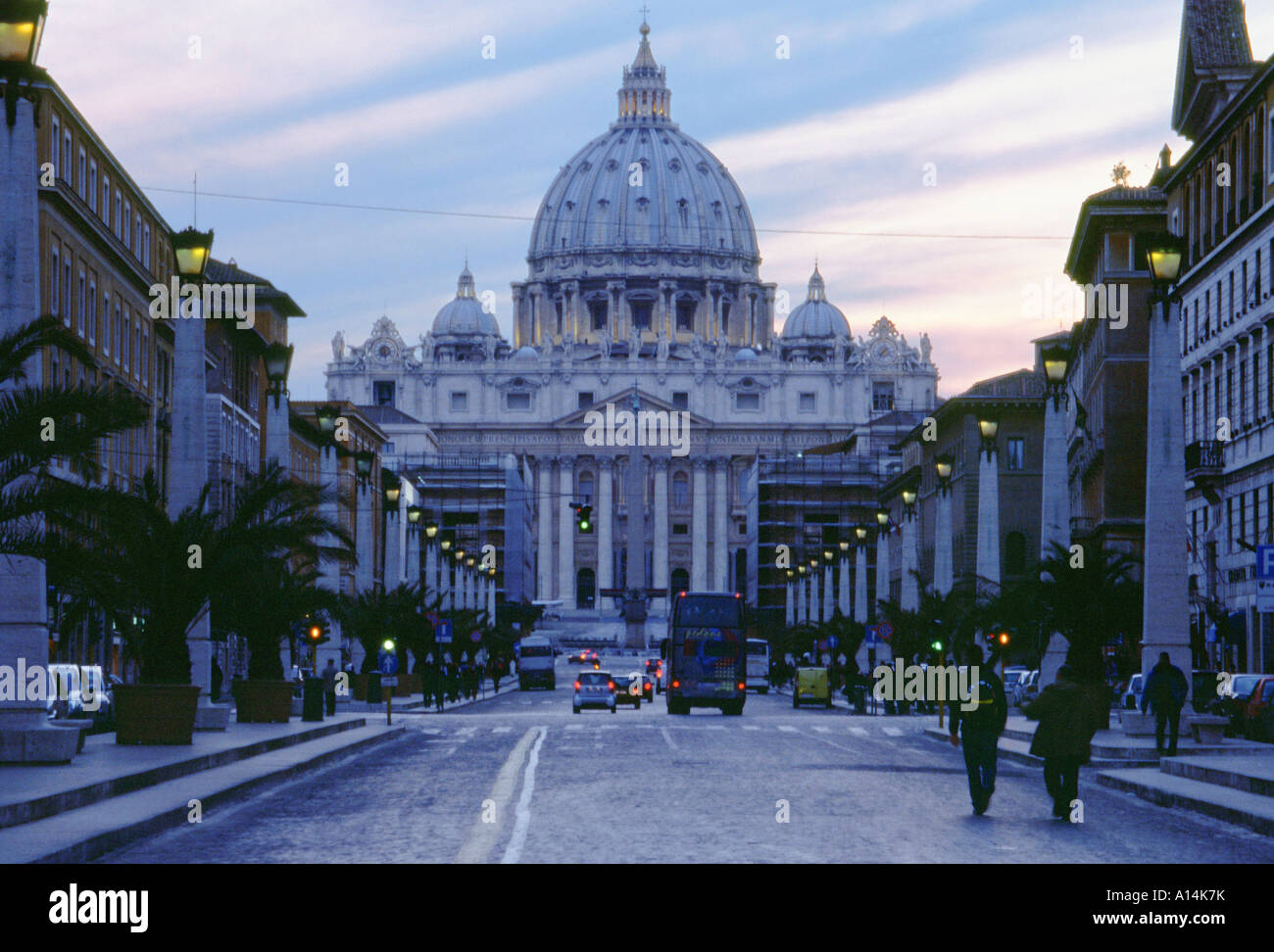 View of St Peters Basilica from lamp lined street at sunset Vatican City Rome Italy Stock Photo