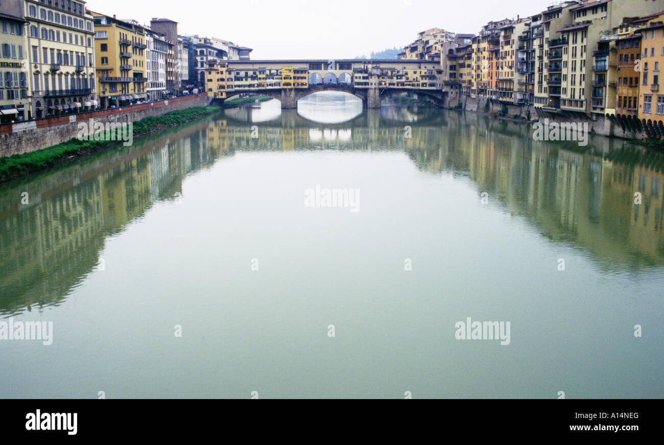 View of Ponte Vecchio Bridge and buildings lining Arno River in spring rain Florence Italy Stock Photo