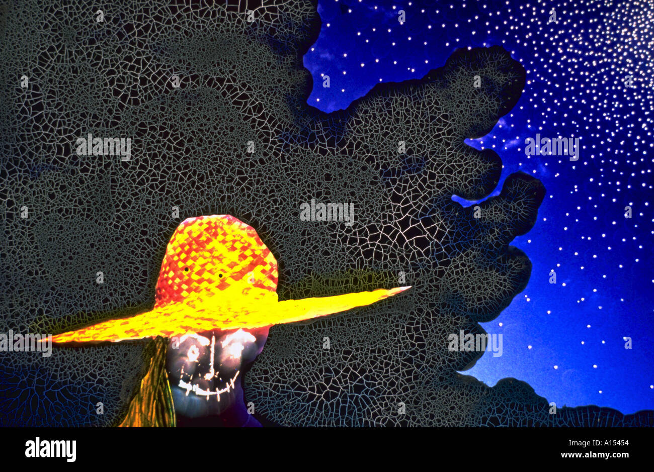 A computer montage of a skull or wearing a wide brimmed yellow and red hat with a crackled pattern Stock Photo