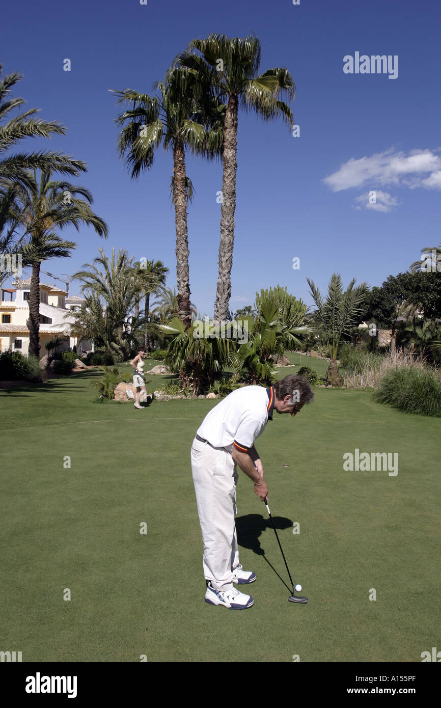 Couple practising golf putting Stock Photo
