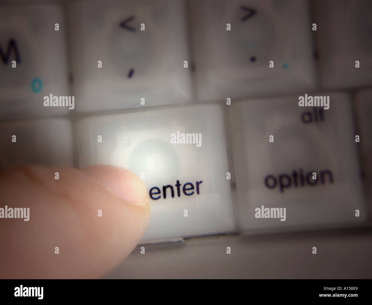 Finger pressing Enter key on a computer keyboard David Hughes Stock