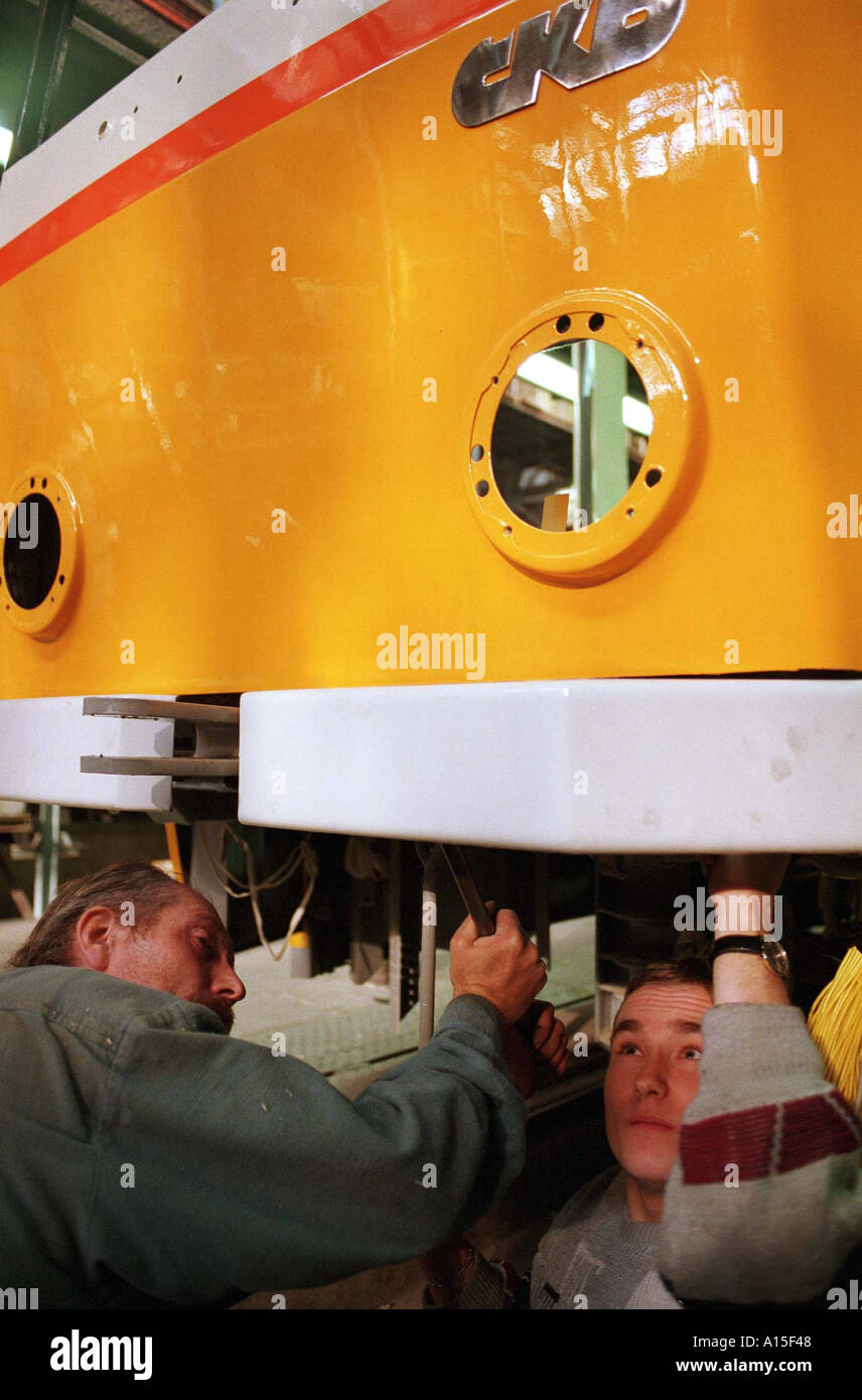 Workers prepare a tram at the CKD tram and train factory in Prague Monday October 25 1999 in the Czech Republic. Stock Photo
