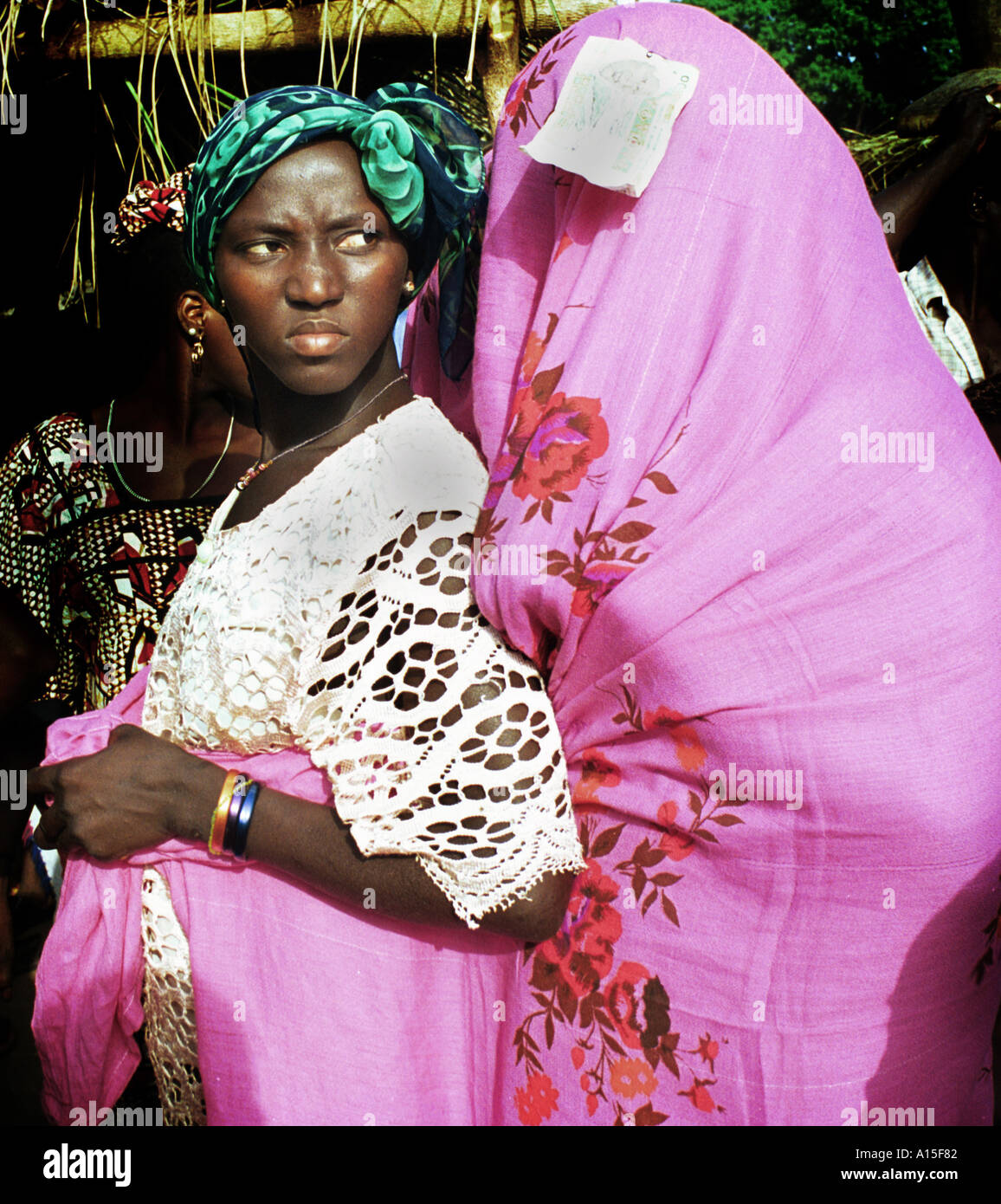 A 13 year-old Muslim bride in the West African country of Guinea Bissau is covered in a pink veil in the last of a three day Stock Photo