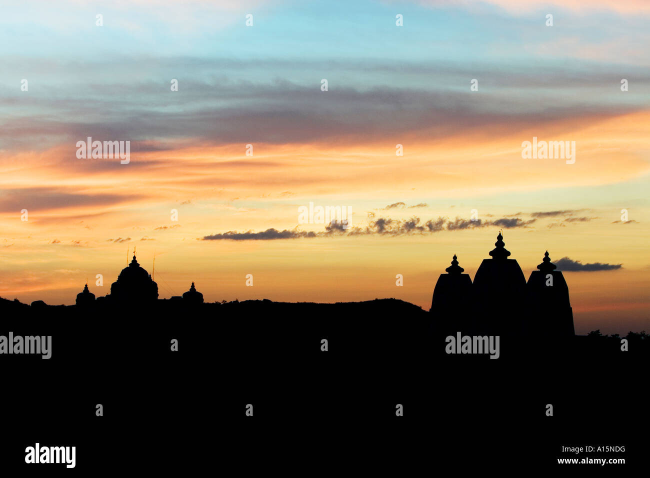 Silhouette profile of Indian ashram architecture against sunset at Puttaparthi, Southern India Stock Photo