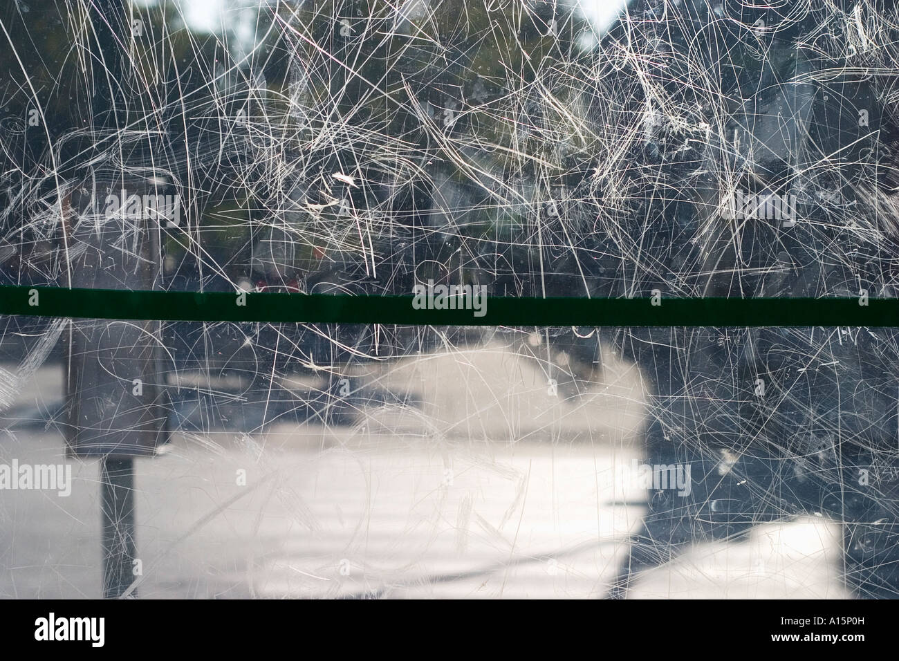 Scratched plexiglass wall of bus shelter Stock Photo
