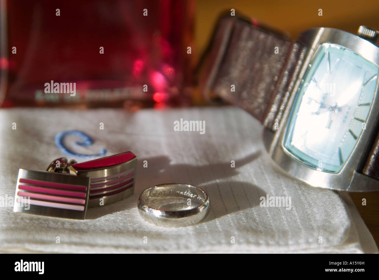 Horizontal close up of a Groom's possessions laid out before his wedding day including his watch, cufflinks and wedding ring. Stock Photo