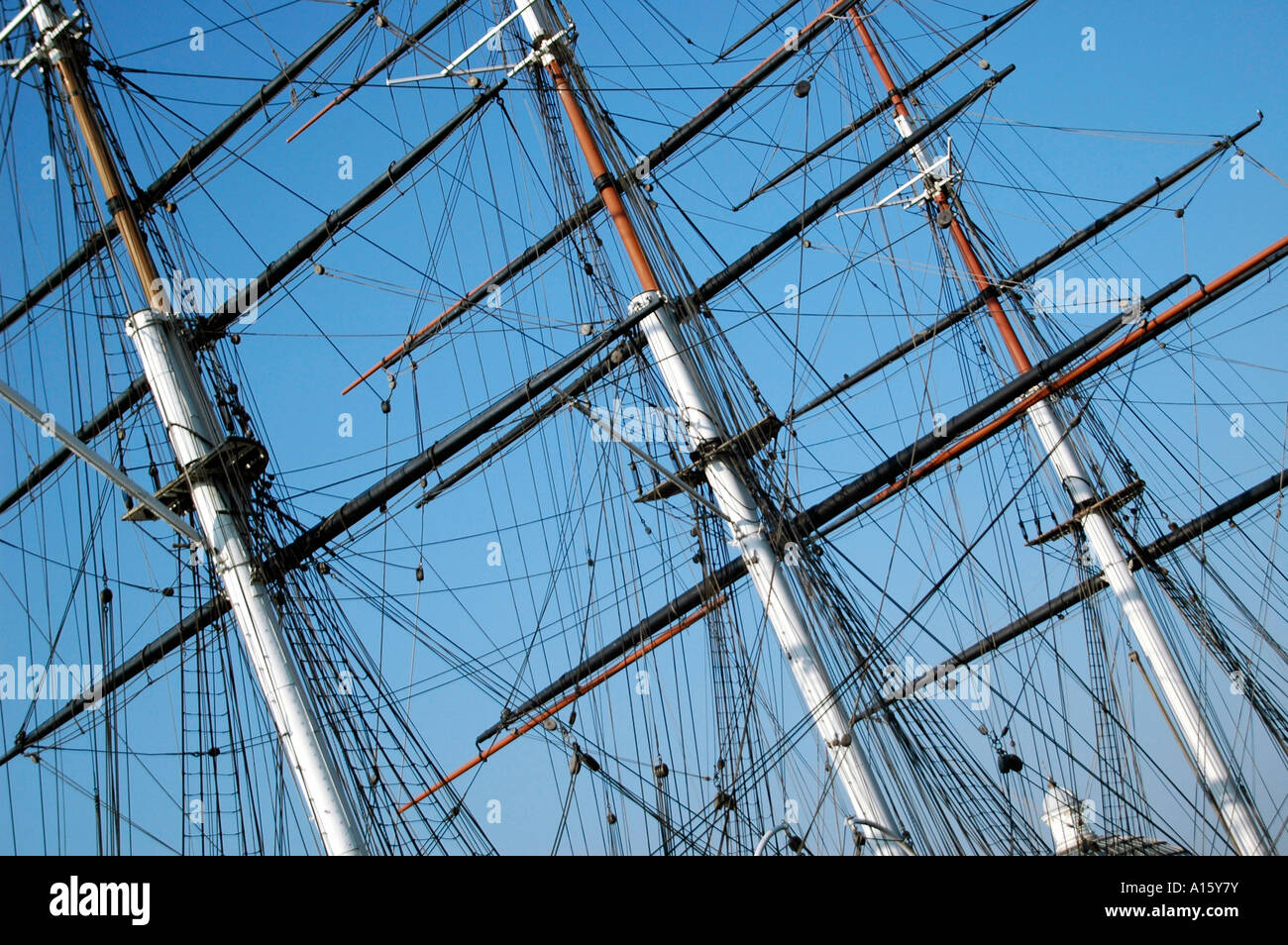 Horizontal close up of the Cutty Sark's rigging and masts against a brilliant blue sky Stock Photo