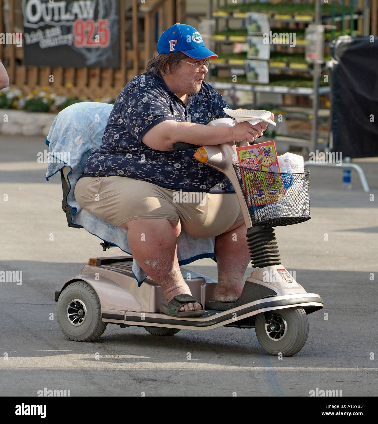 Overweight male on motorized wheel chair eats food Stock Photo - Alamy