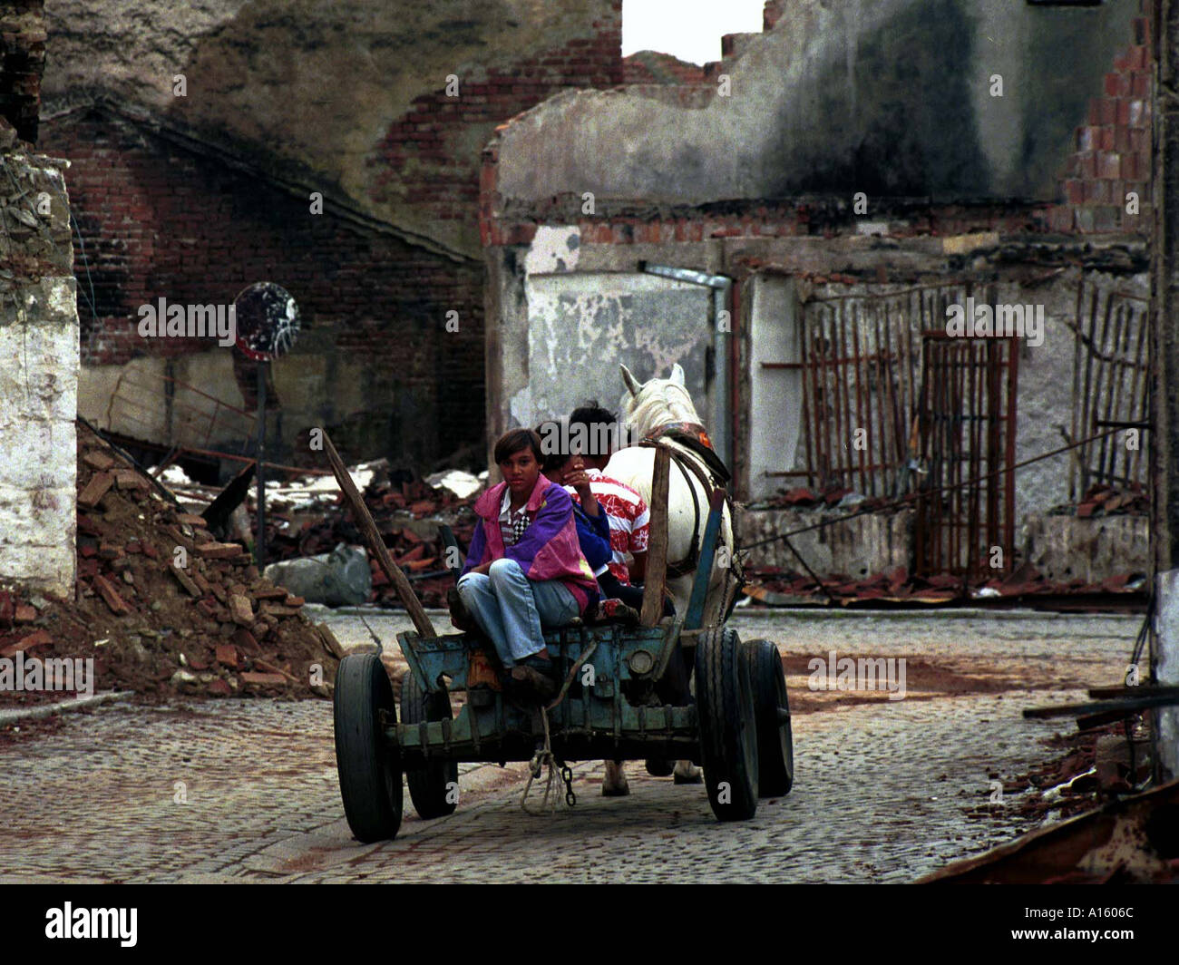 Kosovars survey the damage done by Serbs in the town of Djakove in Kosovo Friday June 18 1999. (KRT) Stock Photo