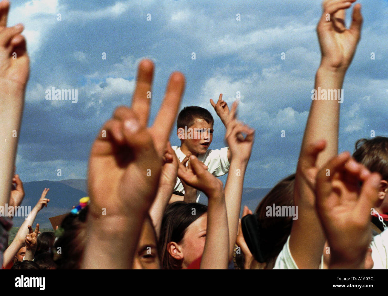 Hundreds perhaps thousands of ethnic Albanian children from Kosovo race around the Brazda camp near Skopje Macedonia chanting Stock Photo