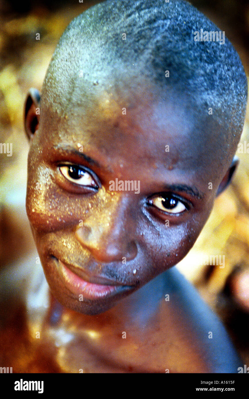 A Senegalese boy of the Wolof ethnic group poses for a portrait in the extreme heat of the Casamance region between Senegal and Stock Photo