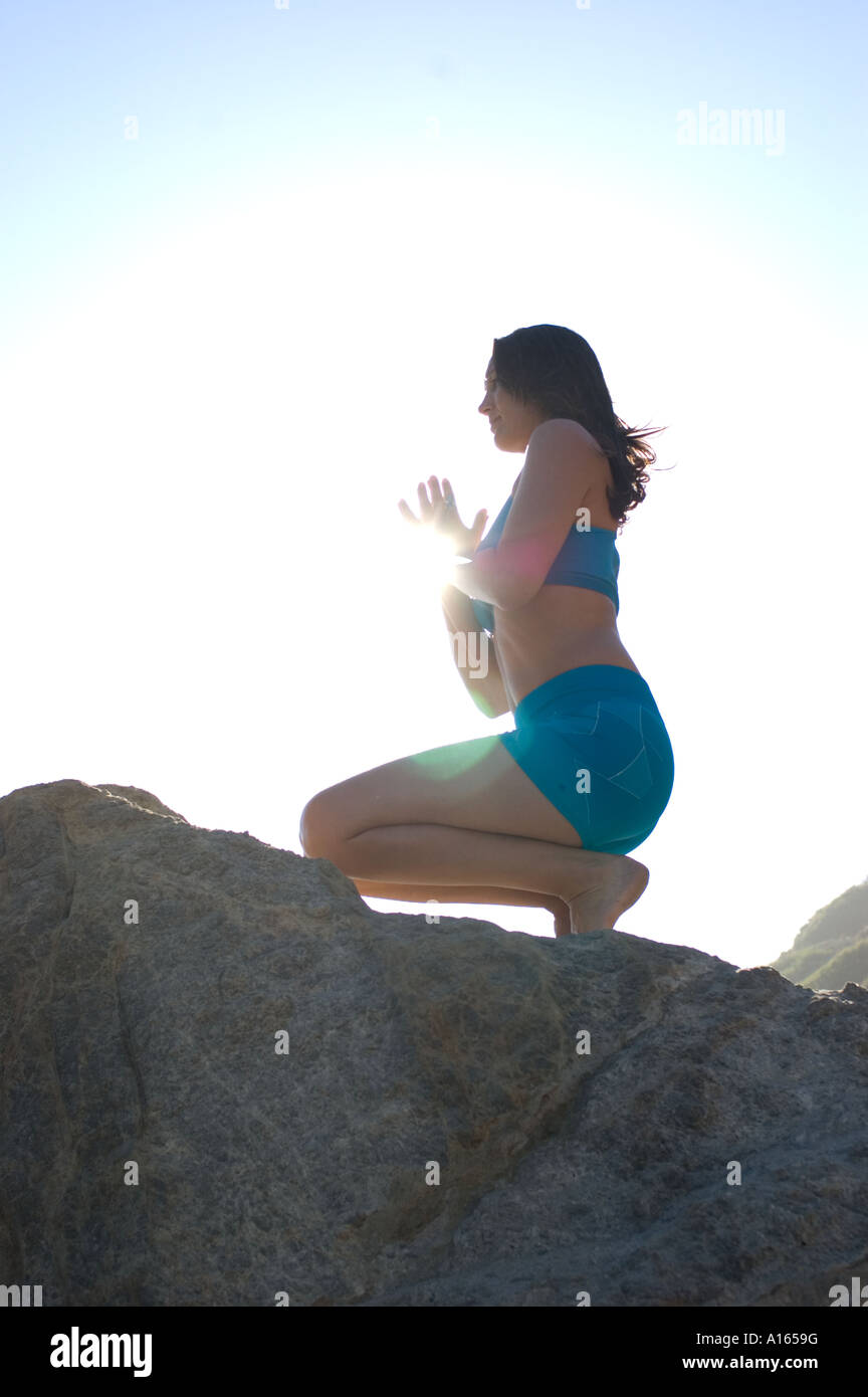 Woman praying on knees in light hi-res stock photography and images - Alamy