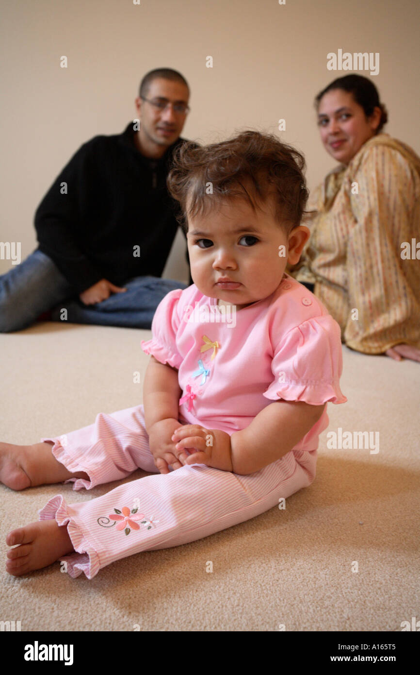 Colour vertical portrait of Moroccan mother and father with their baby