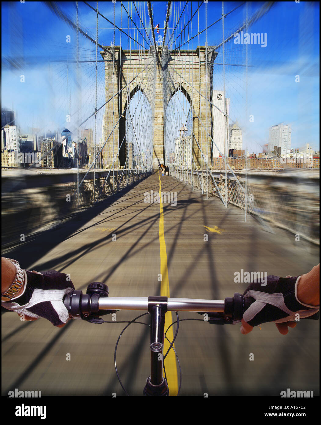 Hand on handlebar of bicycle cycling over Brooklyn Bridge Stock Photo