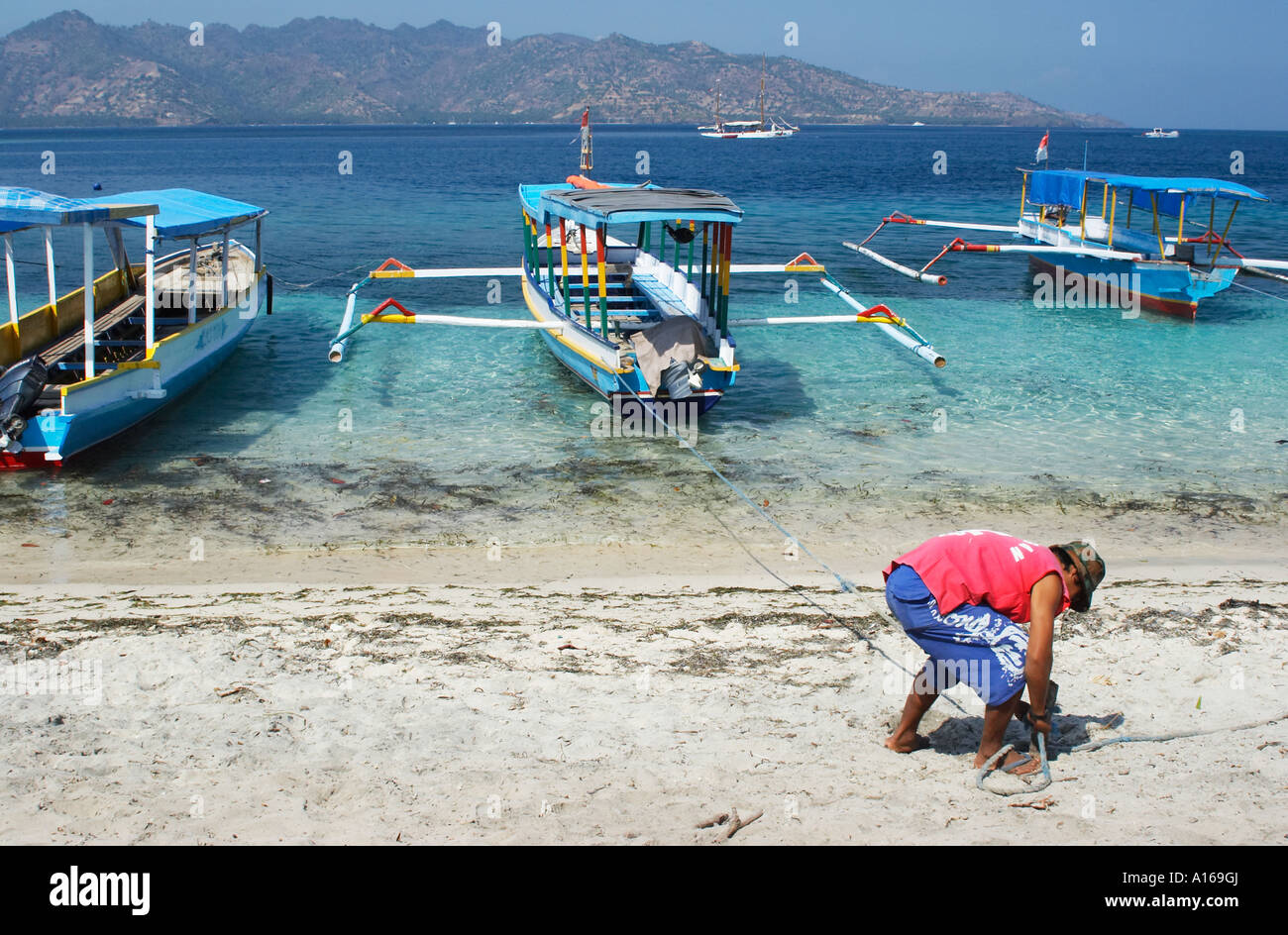 asian man holding a fishing rod with fishing tool box on the fisherman boat  Stock Photo - Alamy