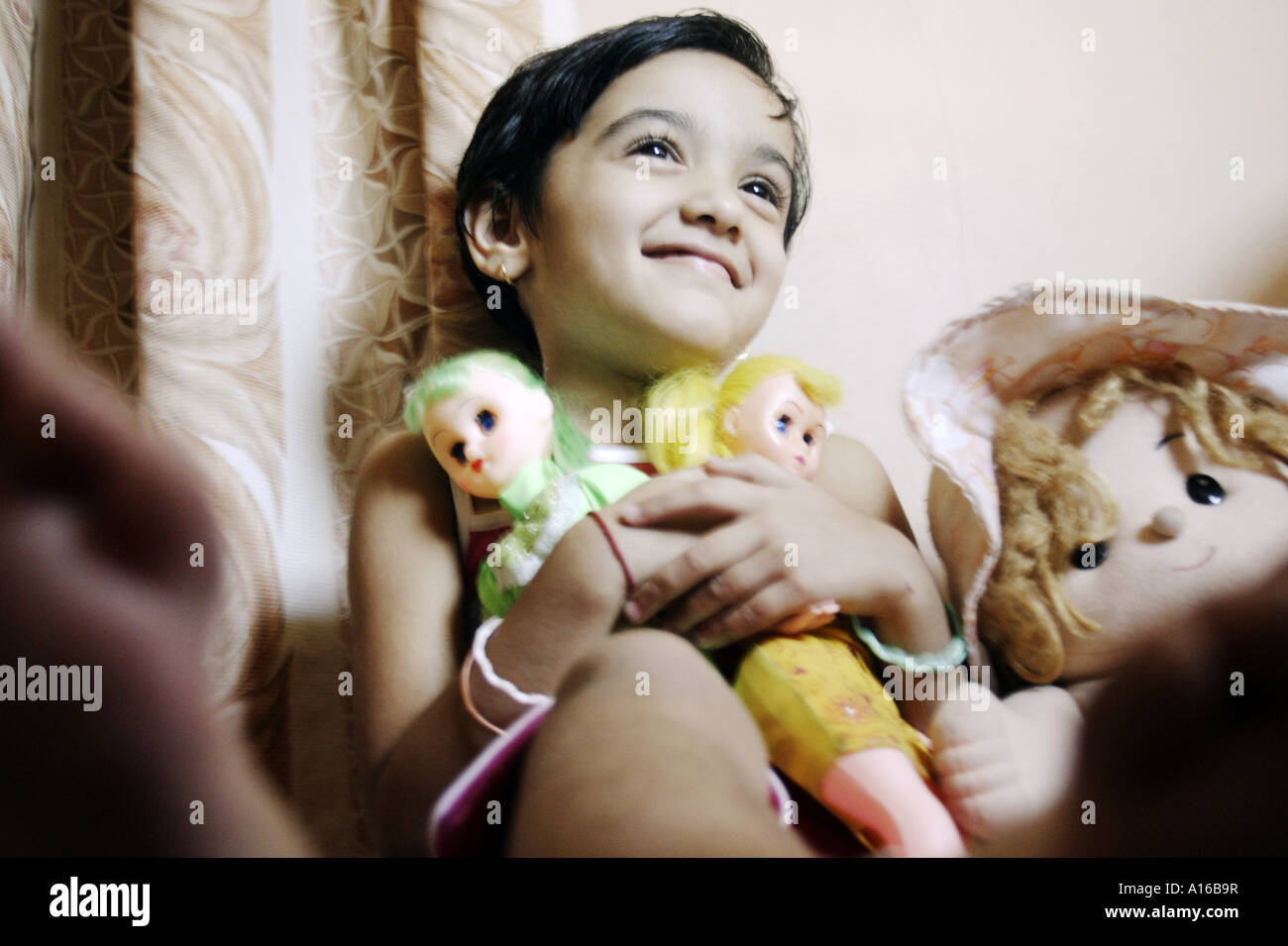 RSC102061 Young Indian little girl smiling with her dolls Bombay Mumbai Maharashtra India Srishti Model released 542 Stock Photo
