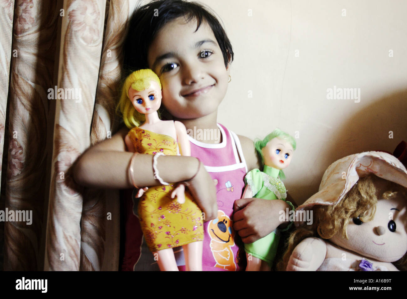 RSC102062 Young Indian little girl smiling with her dolls Bombay Mumbai Maharashtra India Srishti Model released 542 Stock Photo