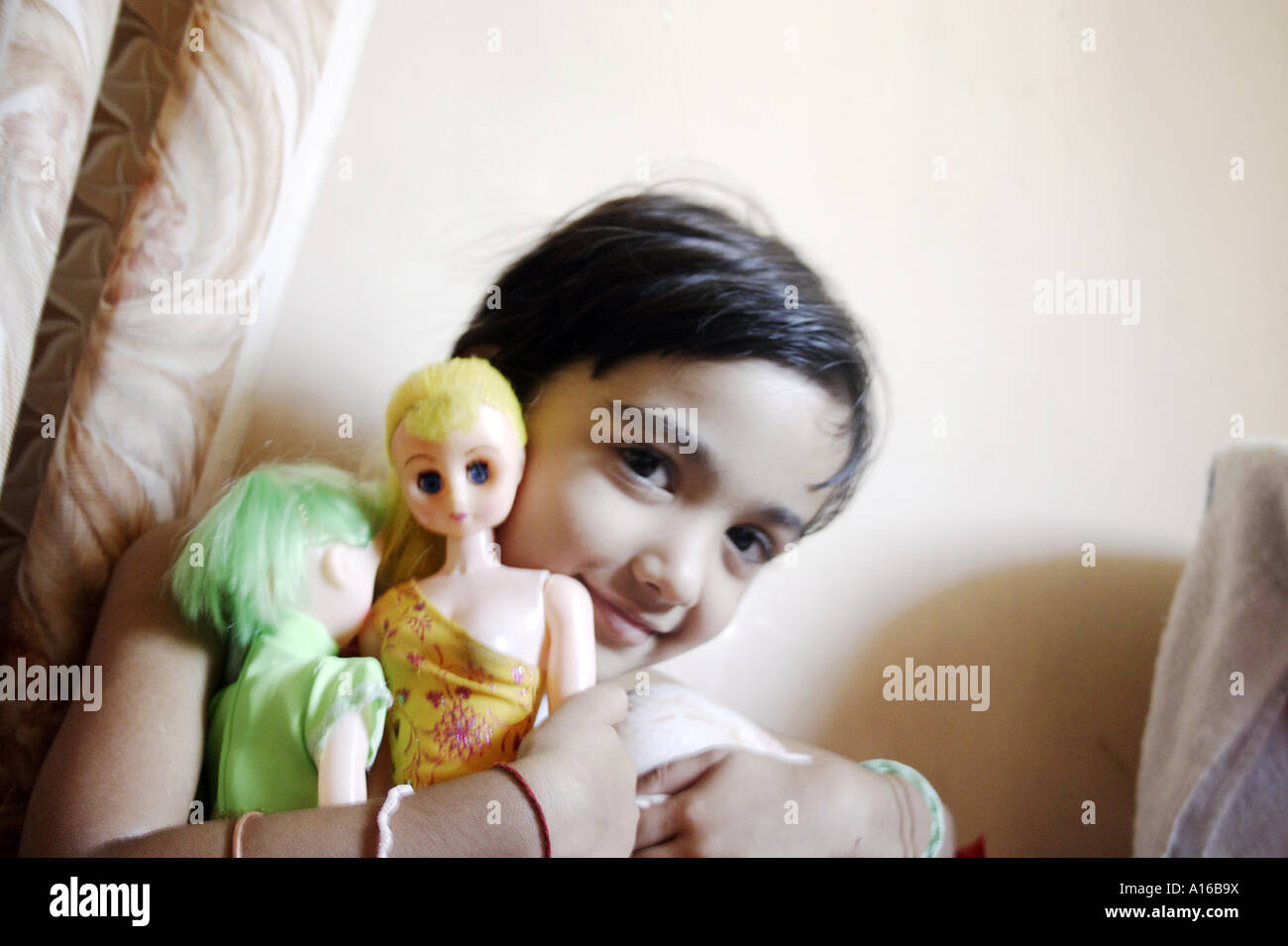 RSC102064 Young Indian little girl smiling with her dolls Bombay Mumbai Maharashtra India Srishti Model released 542 Stock Photo