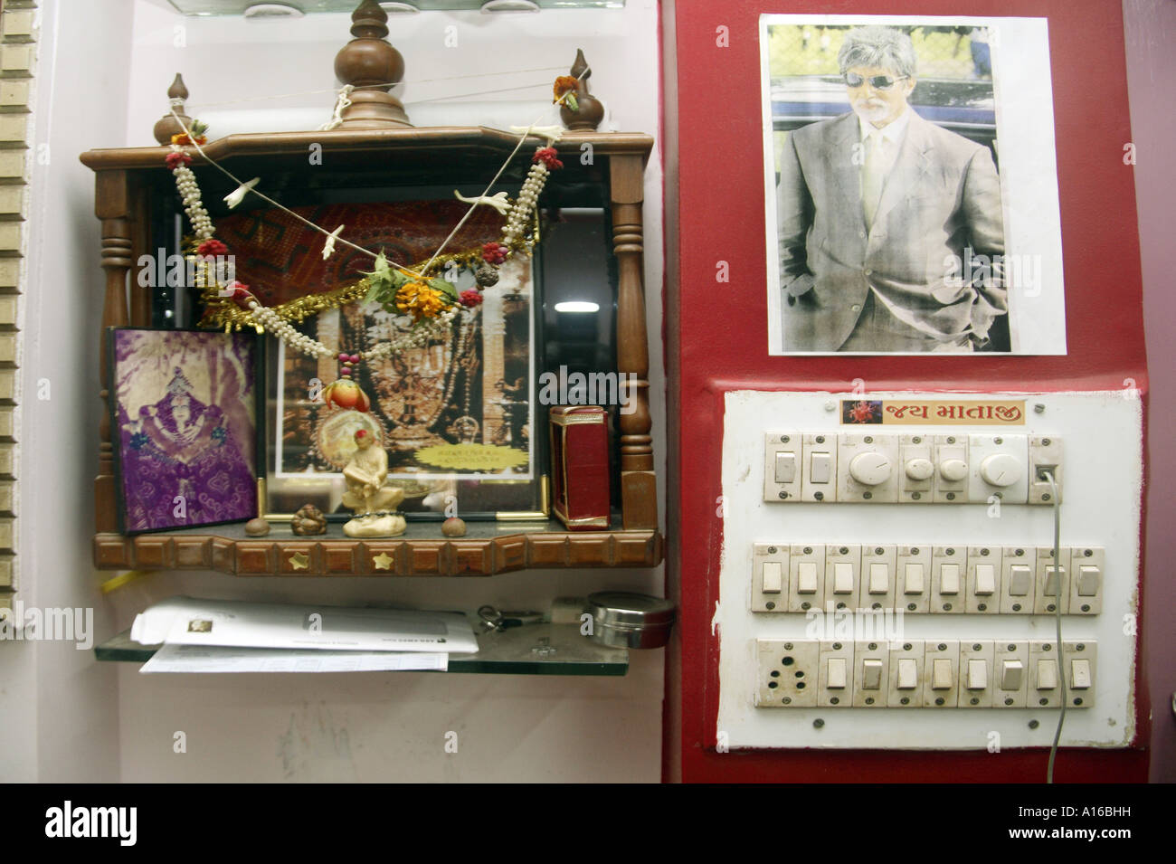 Corner for worship in barber shop with photo of Indian film superstar Amitabh Bachchan Stock Photo