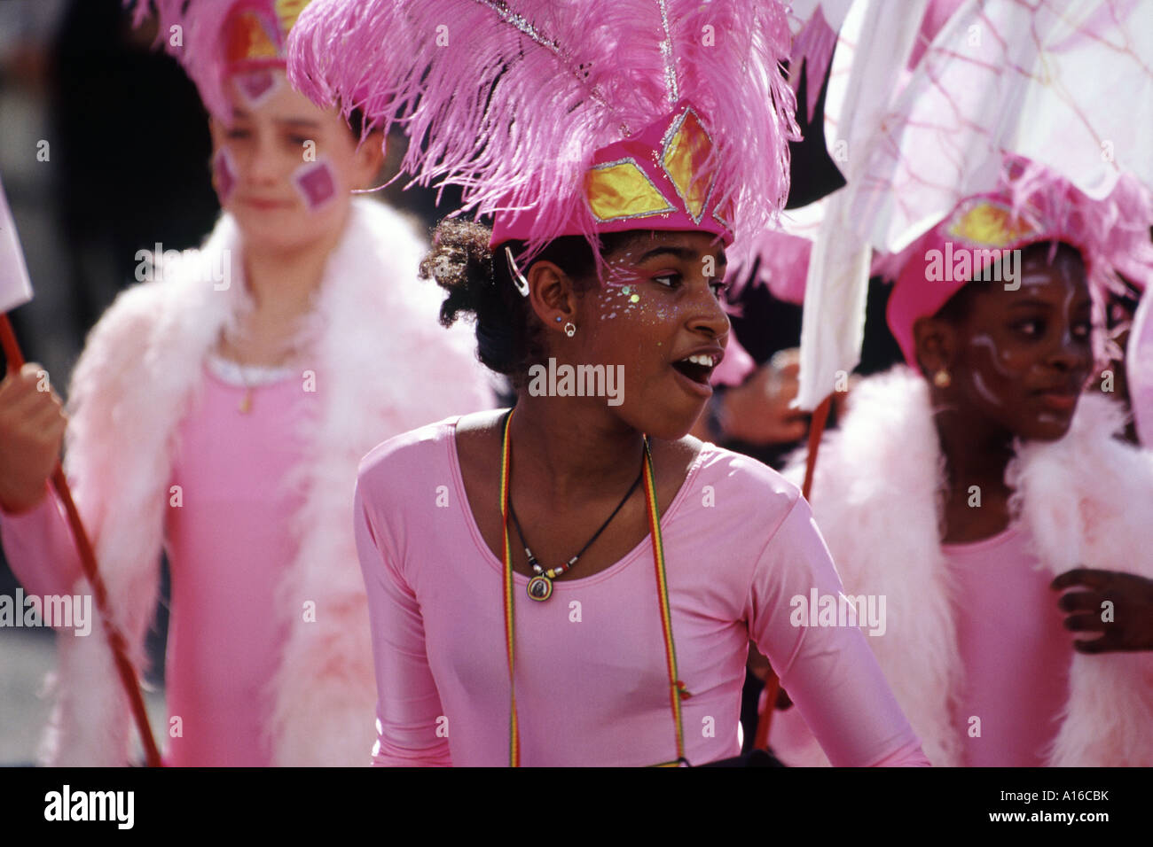 A young African girl in pink costume and feathered hat dancing in the streets at the Notting Hill Carnival London 2000 Stock Photo