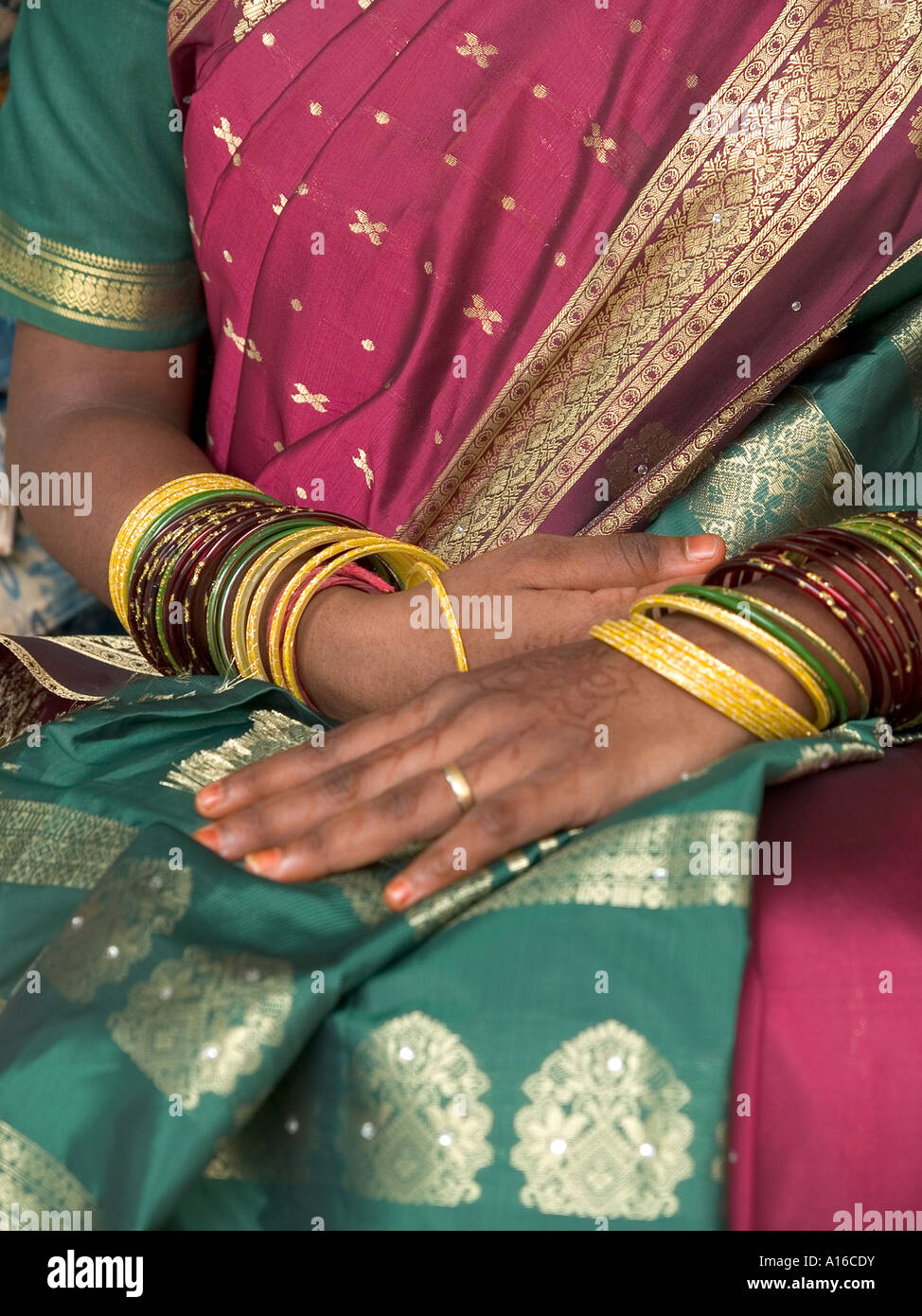 An Indian woman dressed in a traditional sari with multi coloured bangles at the Sri Marianman Hindu temple,  Kuala Lumpur Stock Photo