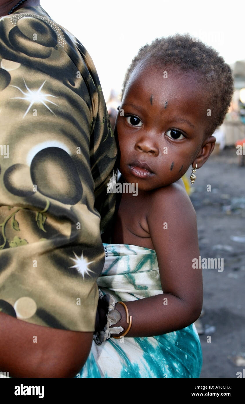 Baby with tribal scars on mothers back , Lome cental Marche , Togo