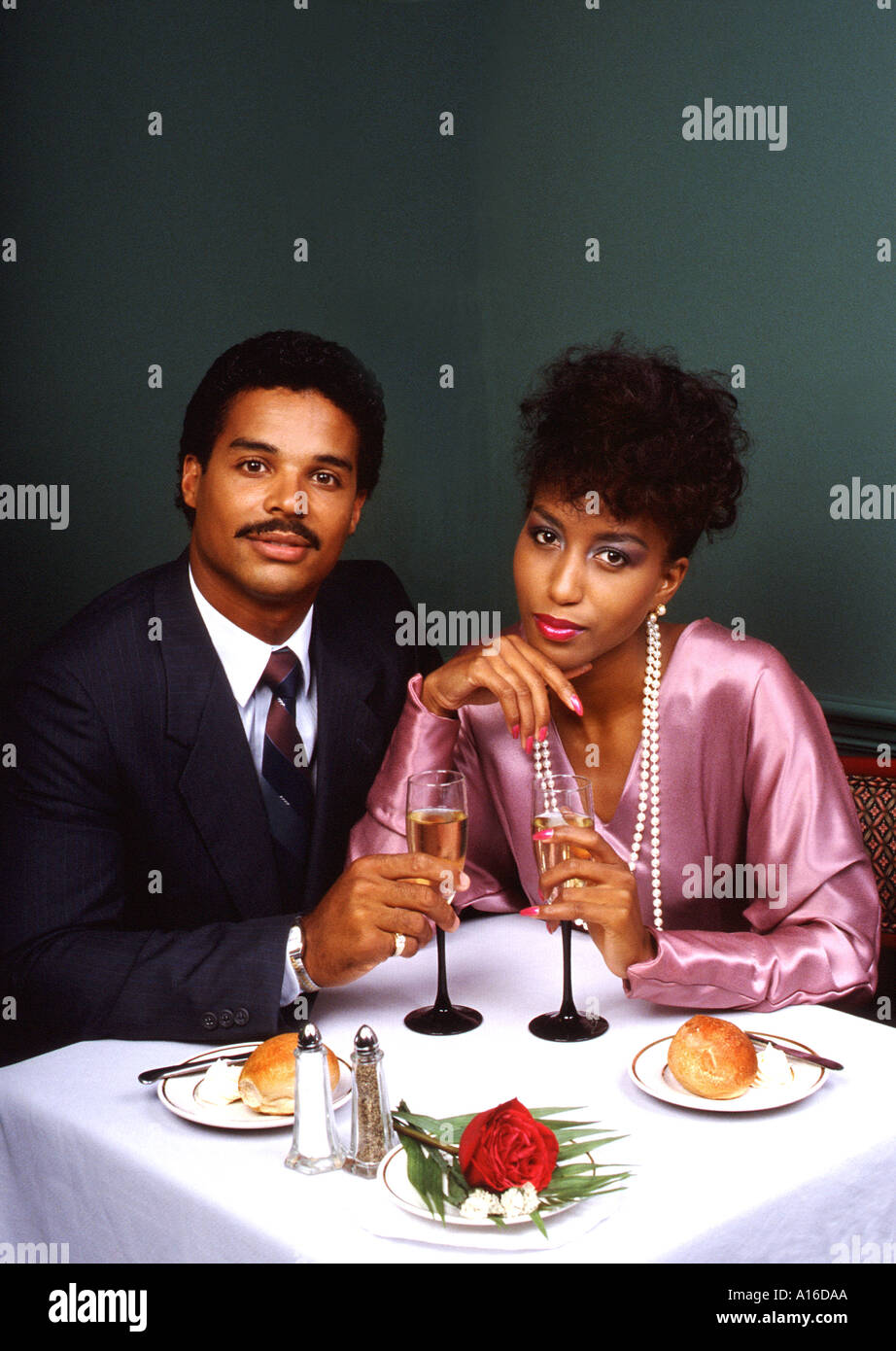 Fine dining African American couple enjoying dinner at upscale
