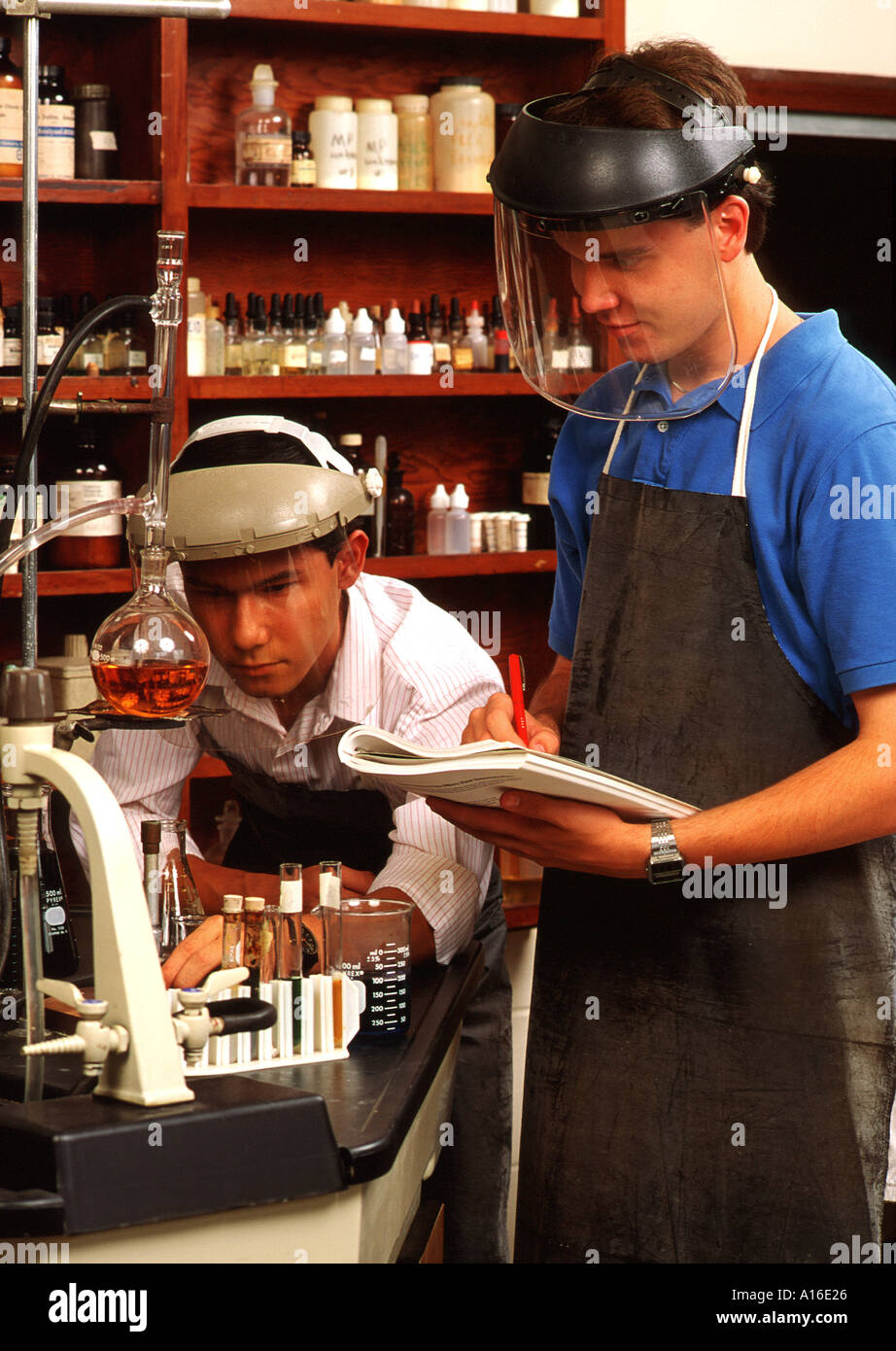 High school two boys wearing protective gear in science class Stock Photo