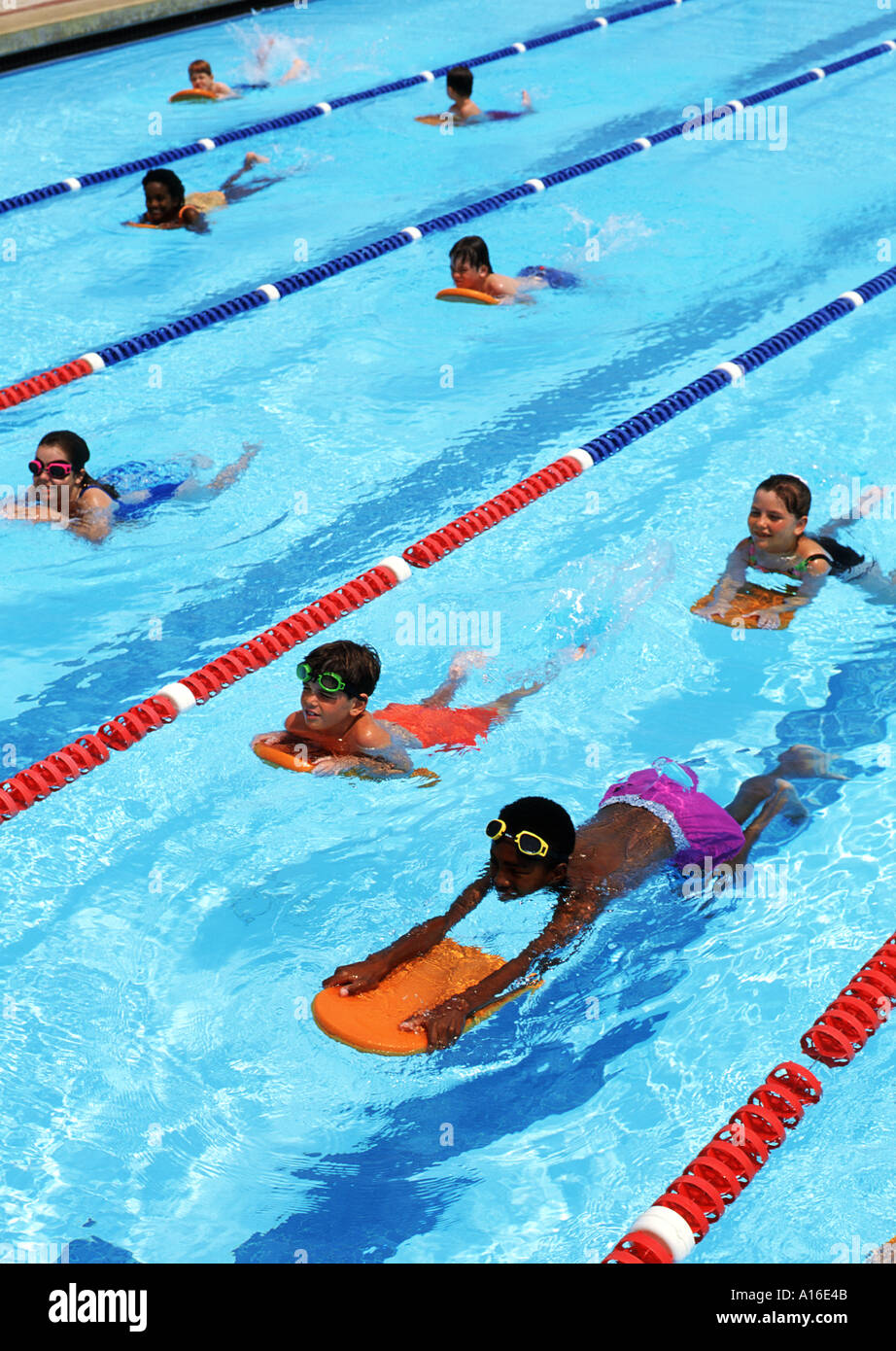 Children learning to swim mixed races in lanes competing Stock Photo