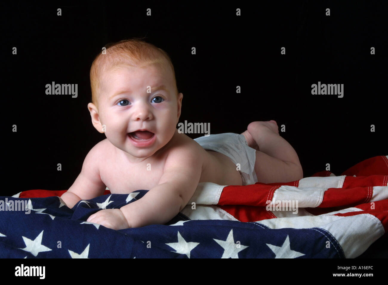 Baby Girl Wearing Diaper Lays On Red White And Blue American Flag Stock