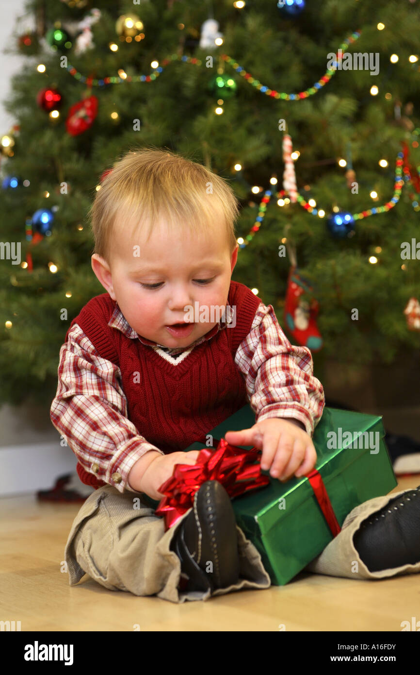 One year old boy opening Christmas present Stock Photo Alamy