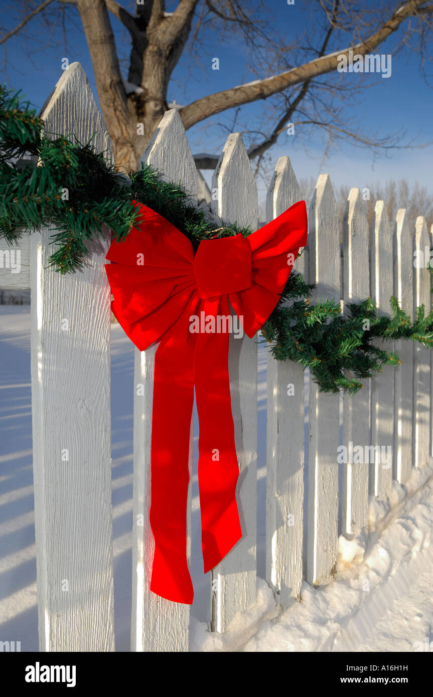 Christmas Decorations On A White Picket Fence Stock Photo