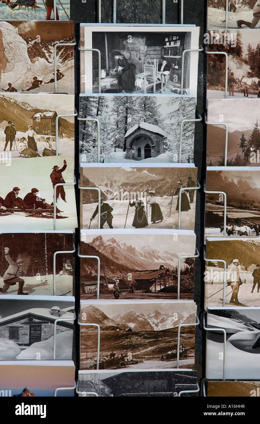 Postcards containing antique images of the Alps in a rack Stock Photo