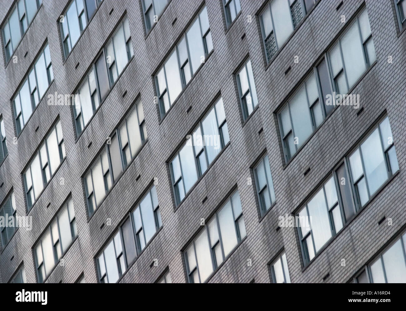 abstract pattern of building facade with bricks and windows Stock Photo