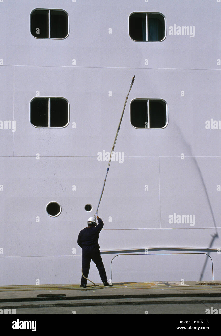 crew member washing the exterior side of a cruise ship Stock Photo Alamy