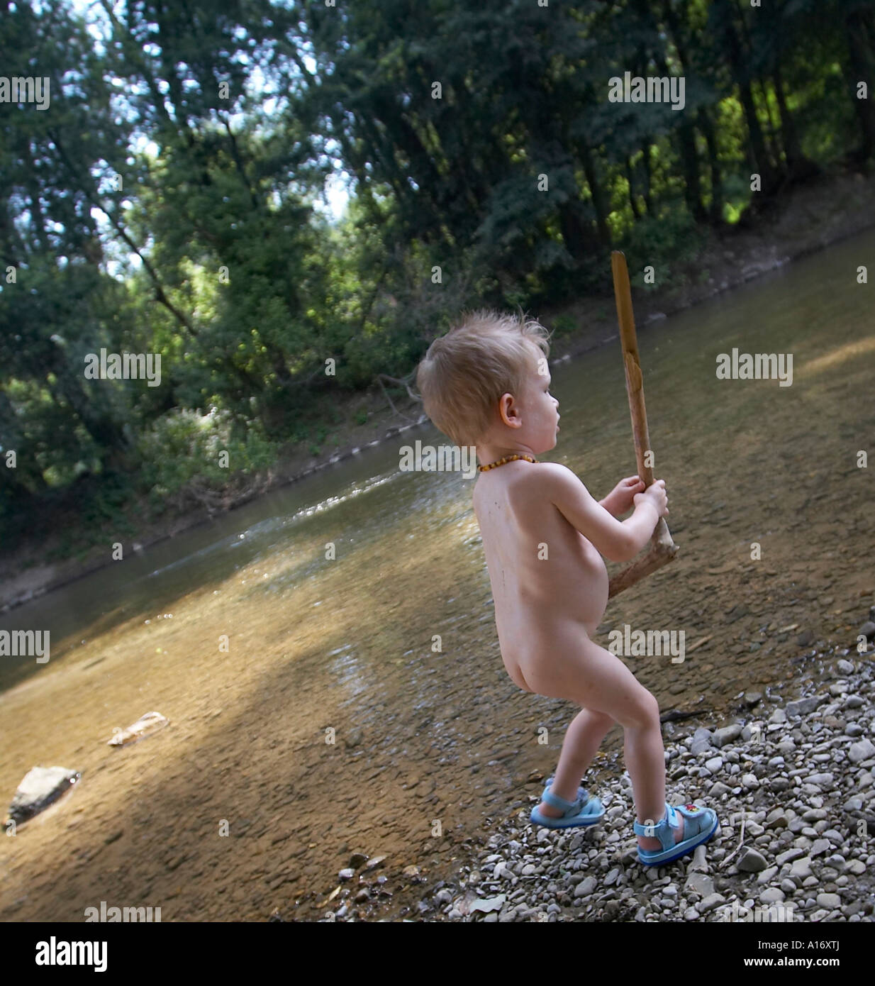young little naked kid boys an girls Little naked boy playing at the river bank Stock Photo - Alamy