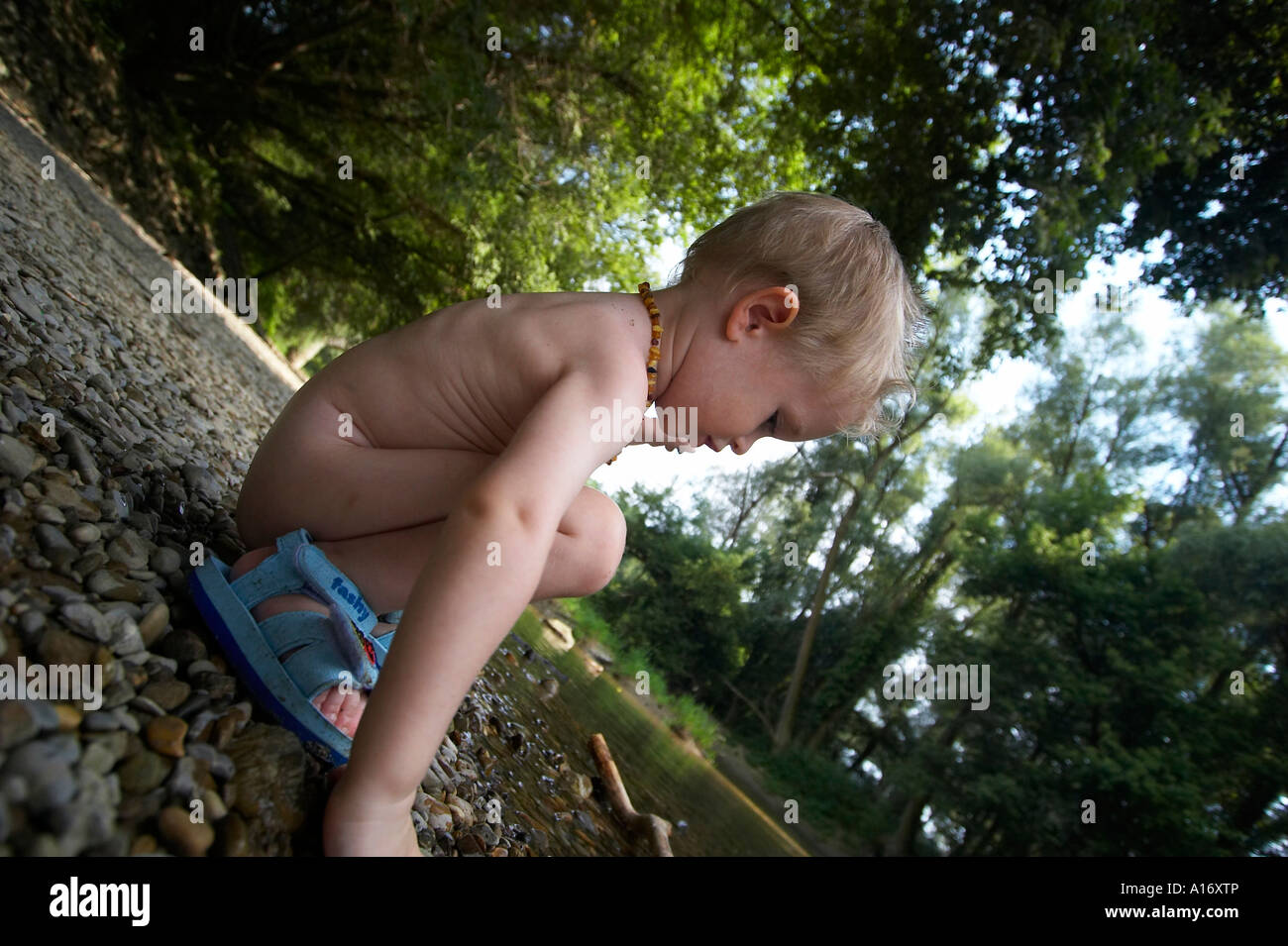 naked little kids  Little naked boy playing at the river bank Stock Photo - Alamy